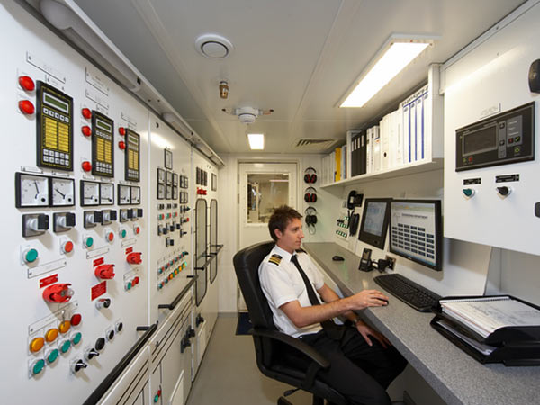 Superyacht chief engineer at his station
